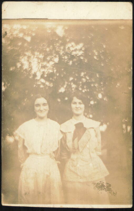 Two Young Women Posing Outdoors