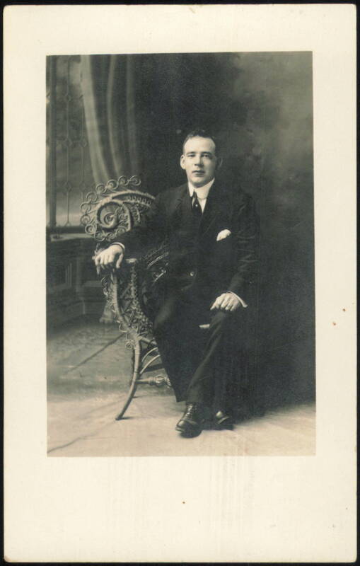 Man in Suit Sitting in Ornate Wicker Chair Men