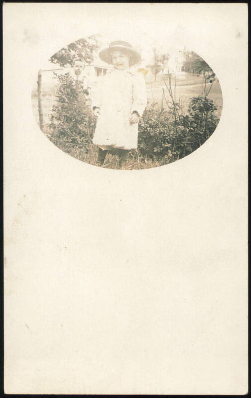 Young Child in Hat and Coat, Man in Background Children