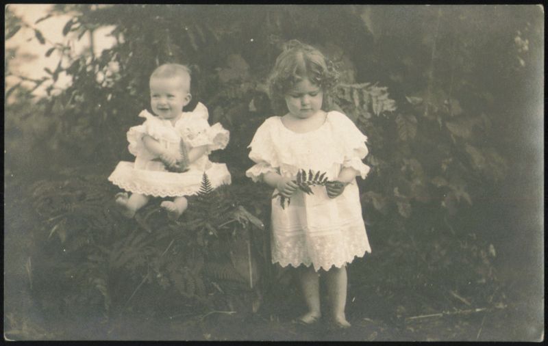 Two Children in White Dresses Outdoors