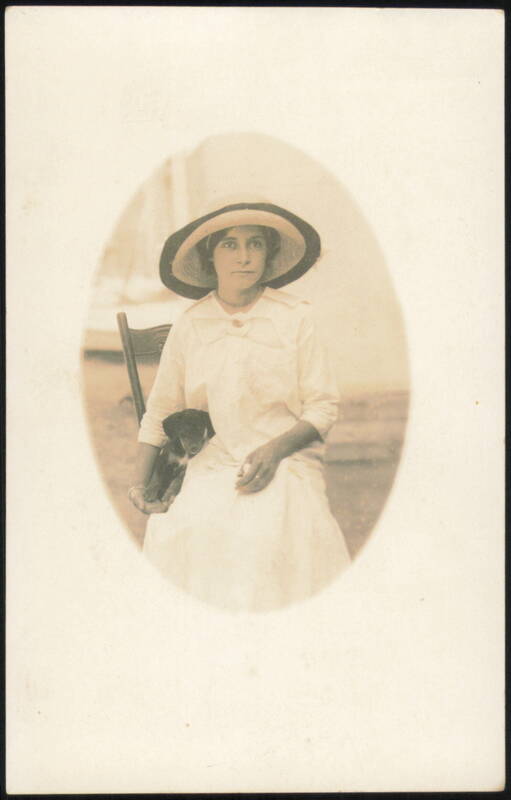 Woman in Hat Holding Puppy Dog Women