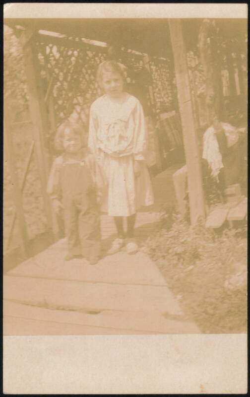 Two Children Outdoors, Older Girl and Younger Child