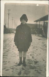 Child in Winter Coat & Hat on Snowy Street Postcard