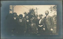 Group of Eight People Posing Outdoors Postcard