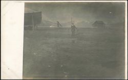 Man with Pole, Boats, Building on Stilts, Mountains Postcard
