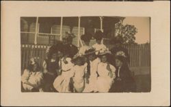 Group of Women & Girls in Hats by House & Fence Postcard