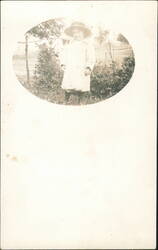 Young Child in Hat and Coat with Man in Background Postcard
