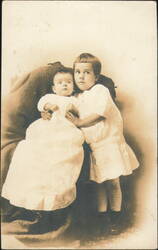 Two Children, Older Child Embracing Baby Postcard