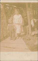 Two Children Outdoors, Older Girl and Younger Child Postcard