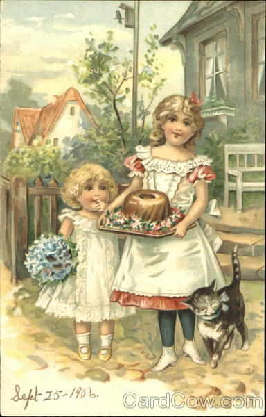 Two girls with a cat presents a birthday cake