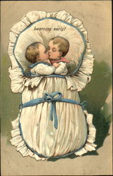 Baby boy and girl kissing in a blanket Postcard