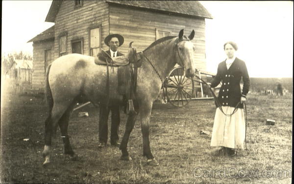 Couple with Horse in Front of House Couples