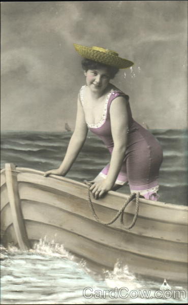 Woman wearing bathing suit in rowboat Women