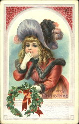 Pretty girl holding a wreath out a window Postcard