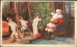 Santa sitting in a chair with Three small children around the tree Postcard
