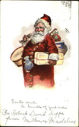 Santa in red suit with many buttons down the front,holding gifts and bag of toys Postcard