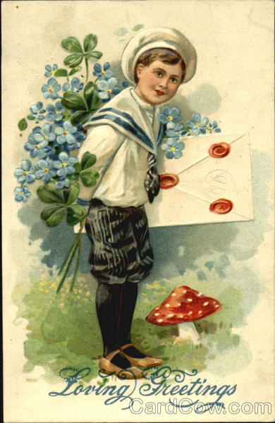 Boy in hat holding flowers and card standing by a mush room