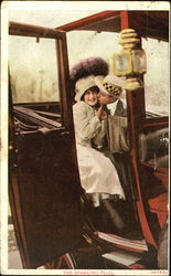 Man stealing a kiss from a girl in a car Postcard