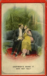 Couple cuddling on couch Postcard