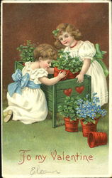 Two girls moving flower pots out of a box Postcard