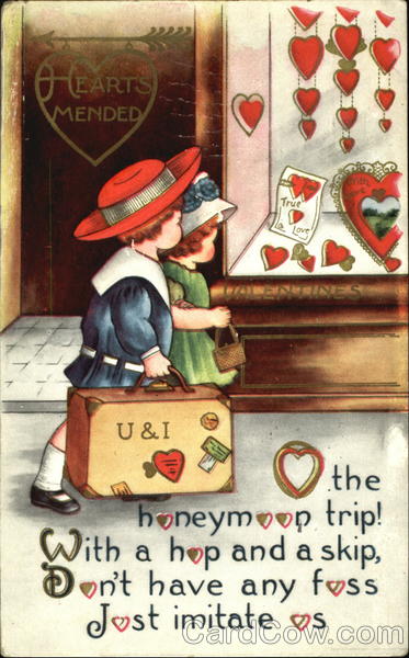 Boy holding suitcase, girl holding purse, walking by store window with red heart