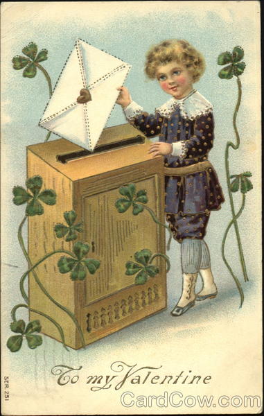 Boy putting valentine into big wooden mail box, clovers