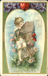 Cupid hanging on old wooden fence Postcard