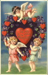 Female cherubs posing on top of and in front of heart shaped flower design Postcard