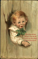 Slightly goofy boy with tear peeking through fence Postcard