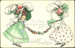 Two girls with fancy bonnets holding a garland of flowers Postcard