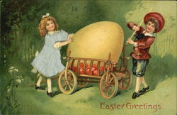 A boy and a Girl getting a large egg out of a wagon Postcard