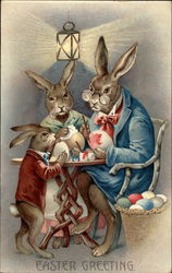 Rabbit family decorating Easter eggs Postcard
