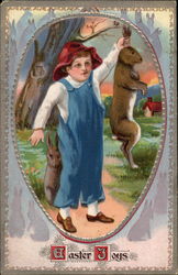 Boy in Overalls Holds Bunny Up by the Ears Postcard