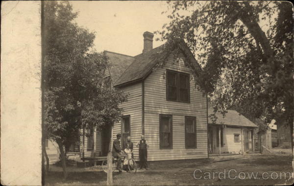 A Family Stands Outside Their Home Bicycles