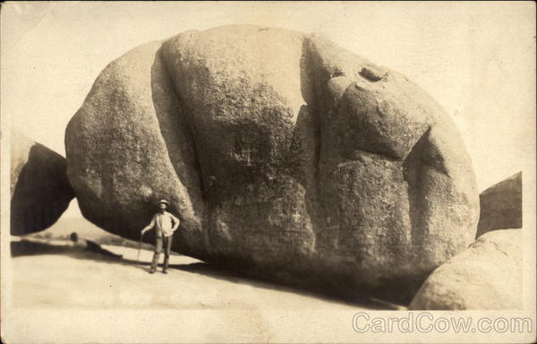 Man before a large rock Men