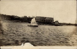 A Sailboat on the Water with Docks in Background Postcard