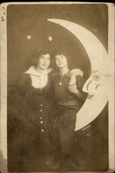 Female Affection - Women sitting on paper moon Moons Postcard Postcard