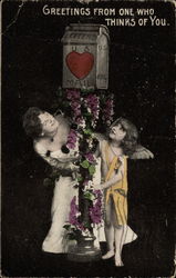 Woman and cupid eyeing post box Postcard