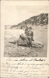 Two men and a girl posing beside lake Postcard