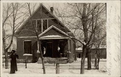 Three women in snow in front of house Postcard