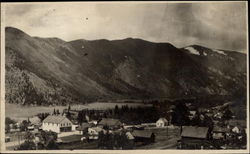 Scene of town at base of mountains Postcard