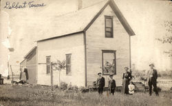 Family in Front of Home Postcard