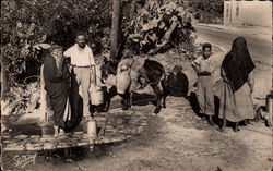 African scene of villagers getting water from well Tunsia Postcard Postcard