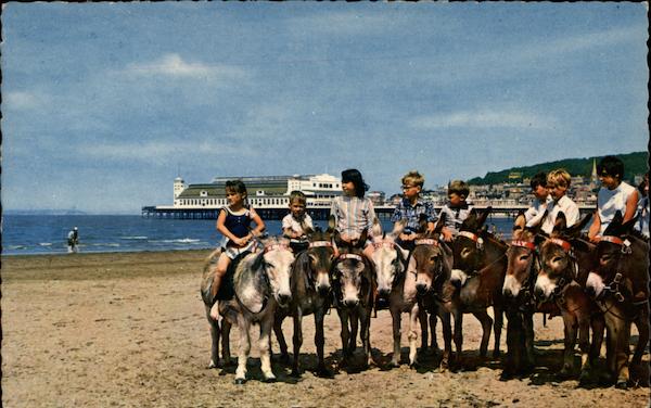 Children Riding Donkeys on Beach Weston-Super-Mare England