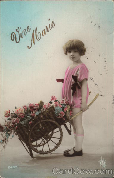 Vive Marie - Young Girl with Wheelbarrow full of Flowers