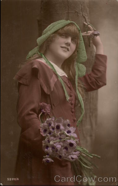 Young Woman in Green Hat and Brown Coat Holding Poppies