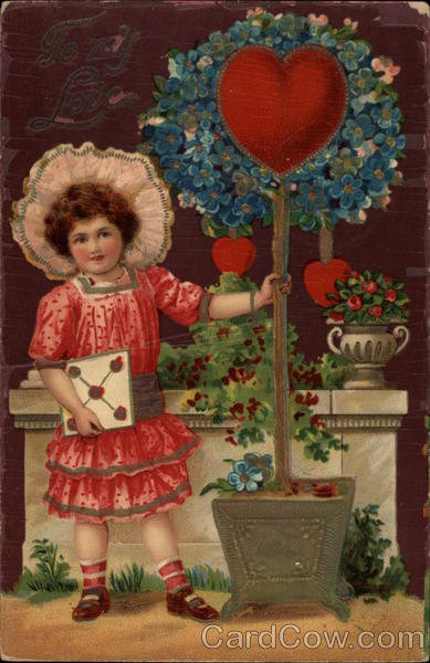 Girl holding tree with heart in center of blue flowers