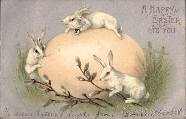 Three White Rabbits on Large Egg With Bunnies