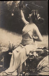 Woman sitting on rock Postcard