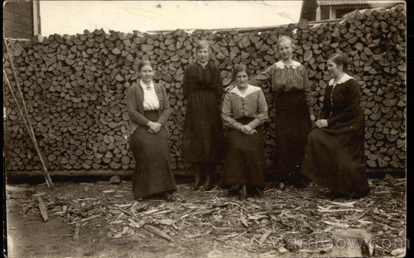 Five Women in Front of Wood Pile